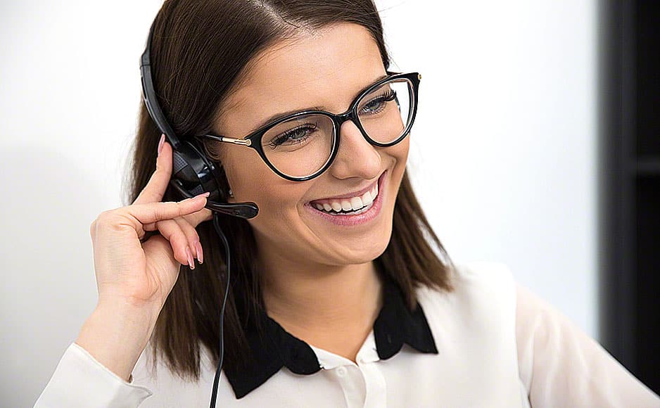 Cheerful female support operator in headset