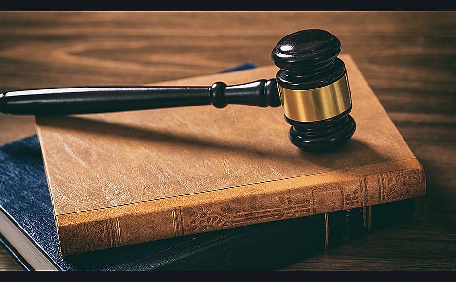 Judge gavel on law books, wooden desk